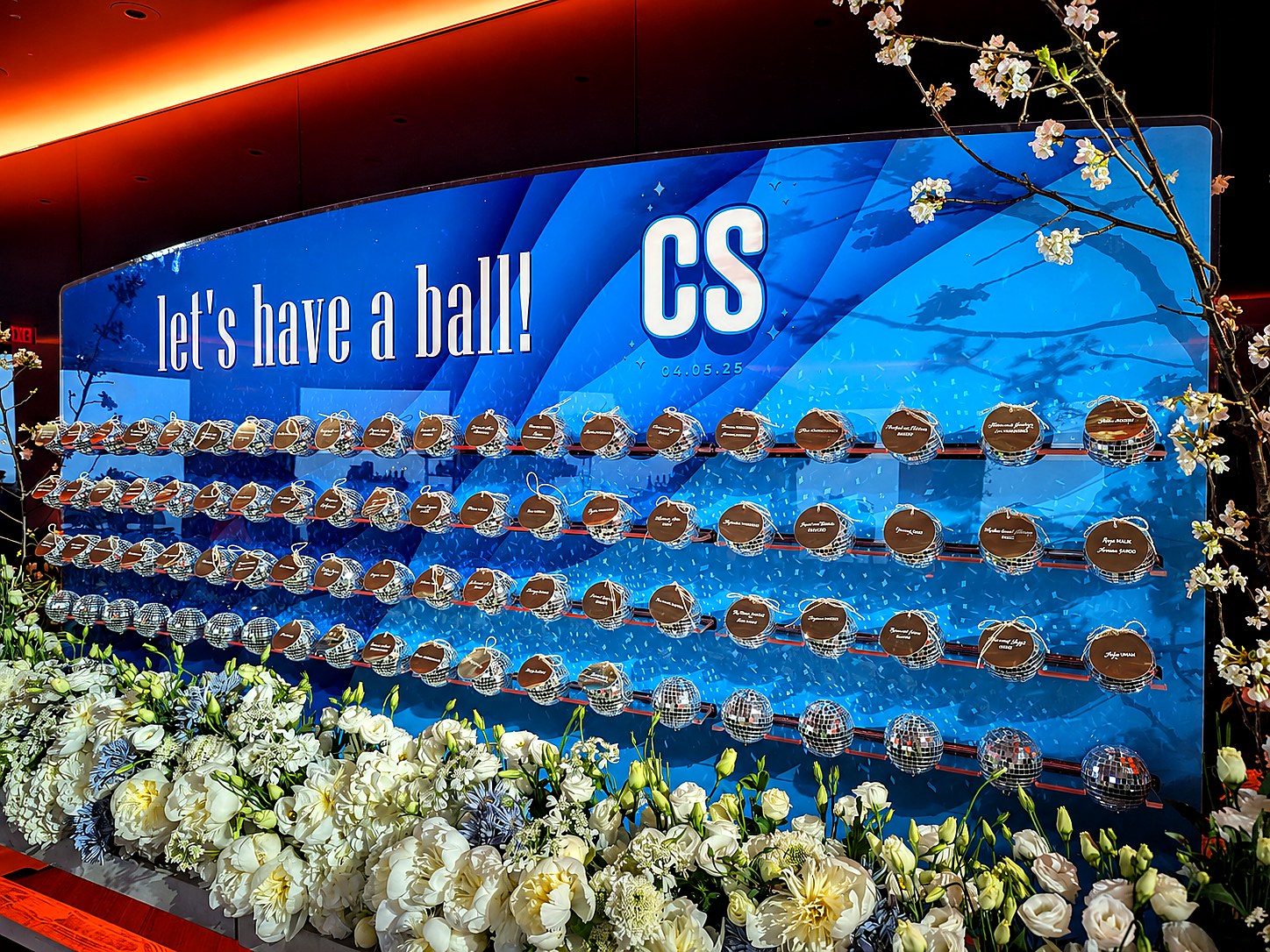 Custom blue disco themed seating display with mirrored spheres and white flowers